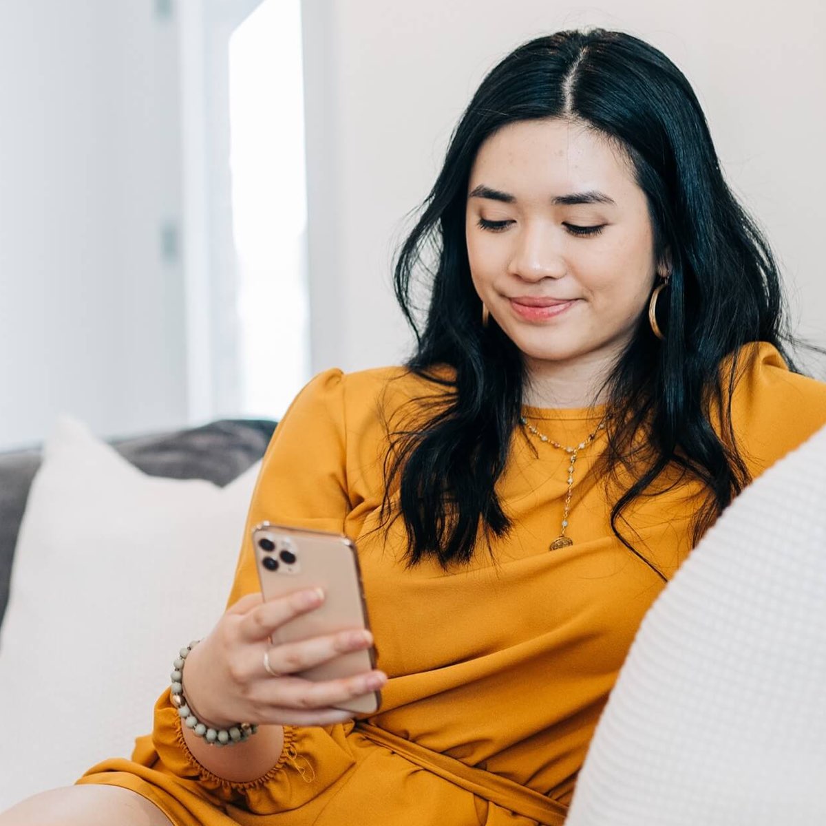 girl on sofa looking at phone