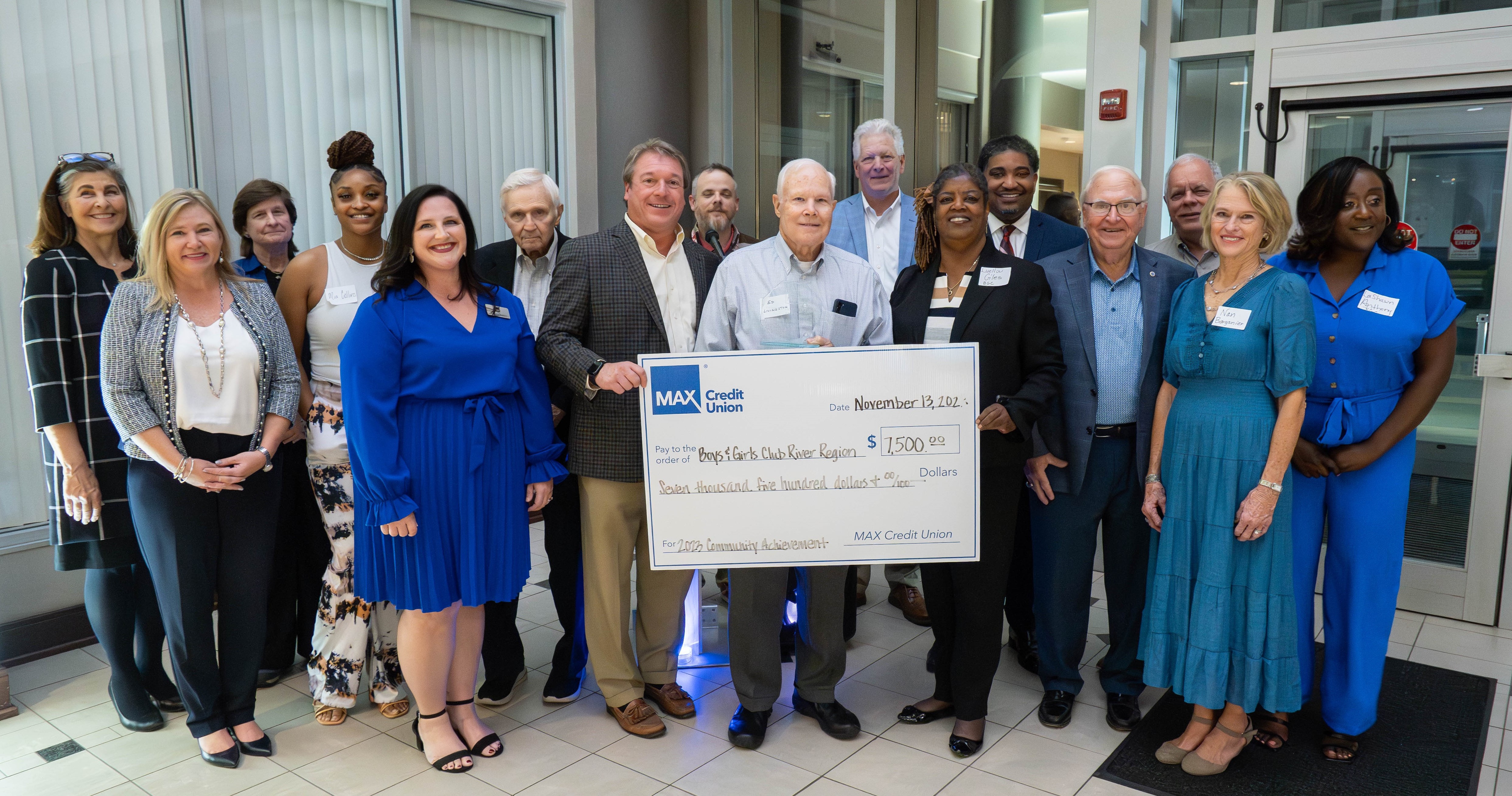 Members from the Boys and Girls Club of the River Region standing with check from MAX Credit Union.