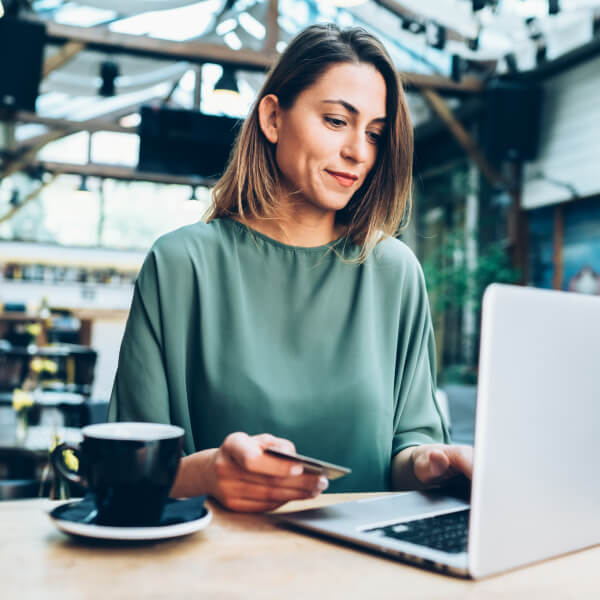 woman with credit card using her laptop