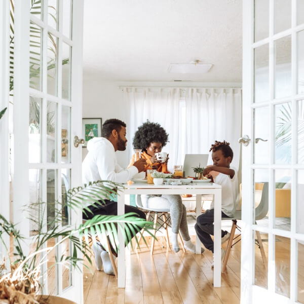 family sitting at the table in their home