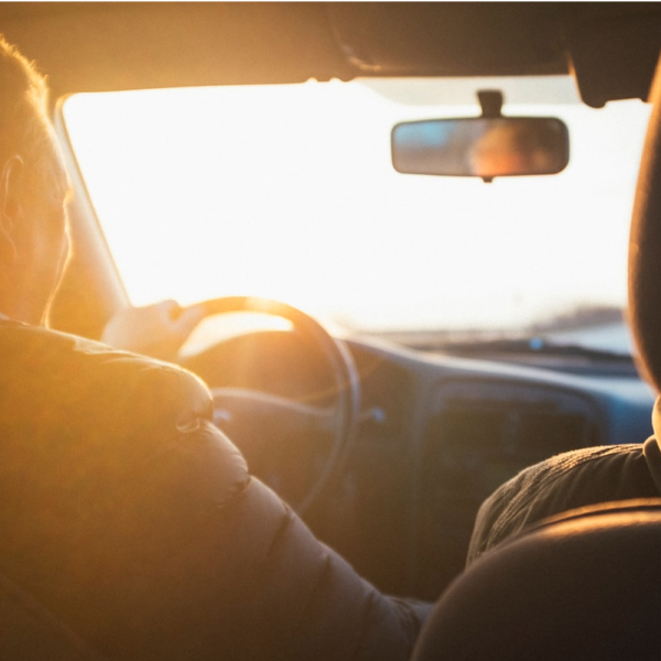 Couple riding in the car together viewing the sunset