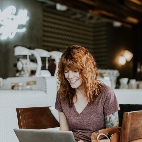 woman in a restaurant on a laptop