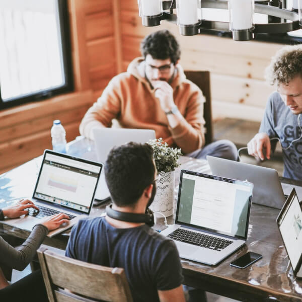 A small group of people in a business meeting using their laptops