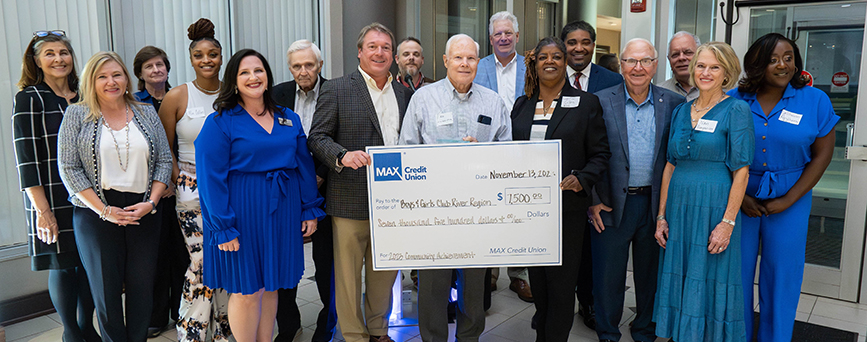Members from the Boys and Girls Club of the River Region standing with check from MAX Credit Union.